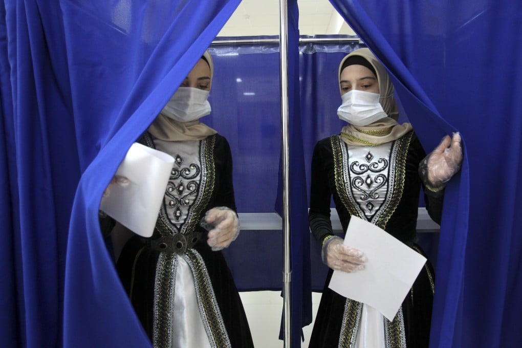 Chechen women wearing Chechen national costumes at a polling booth in Grozny, Russia. Photo: AP