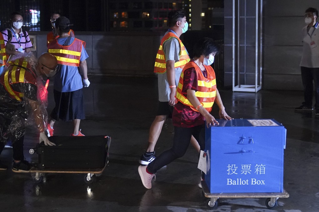 Government officers transport a ballot box at the polling station in Wan Chai on Sunday. Photo: Sam Tsang