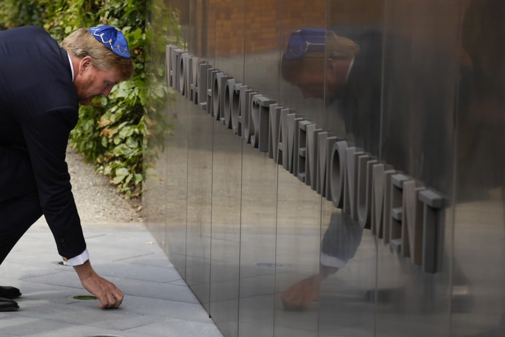 King Willem-Alexander places a stone in an act of remembrance when unveiling a new monument in the heart of Amsterdam’s Jewish Quarter on Sunday. Photo: AP