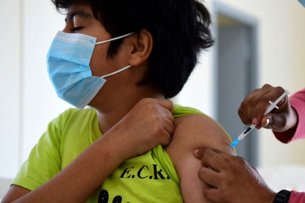 A child receives a dose of the Pfizer-BioNTech vaccine against Covid-19 in Asuncion, Paraguay in July. Photo: AFP