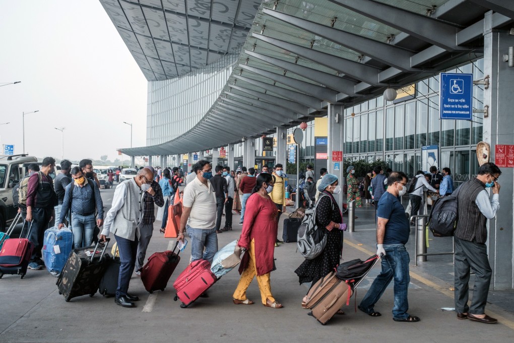Travellers wearing face masks arrive at an airport in Kolkata, India, amid the pandemic. Photo: Bloomberg