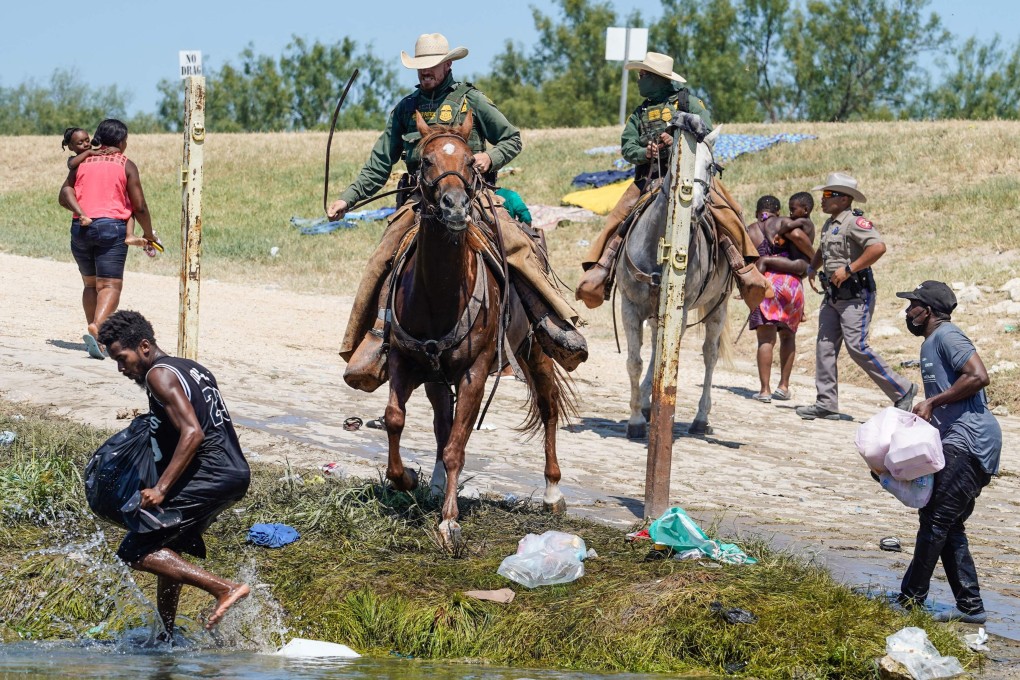 US Border Patrol agents on horseback try to stop Haitian migrants from entering an encampment on the banks of the Rio Grande in Del Rio, Texas, on Sunday. Photo: AFP