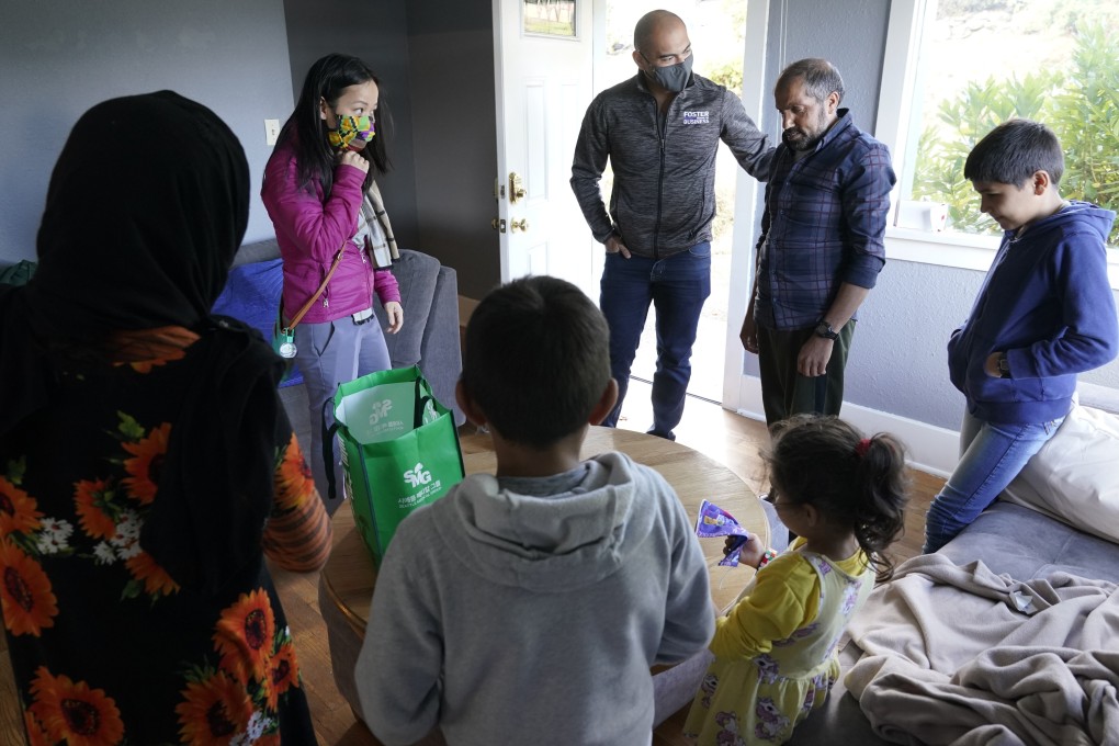 Vietnamese-American Thuy Do, second from left, and her husband Jesse Robbins, centre, talk with Abdul and his family in Seattle. Photo: AP