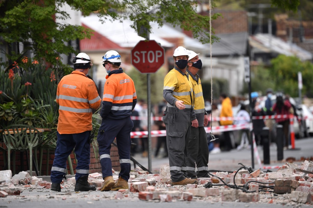 Bricks and rubble are seen strewn across the road in the Windsor suburb of Melbourne following Wednesday morning’s earthquake. Photo: EPA