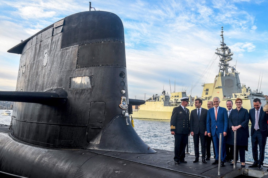 French President Emmanuel Macron, second left, pictured in 2018 standing on the deck of an Australian submarine in Sydney, with former Australian Prime Minister Malcolm Turnbull and other officials. Photo: AFP