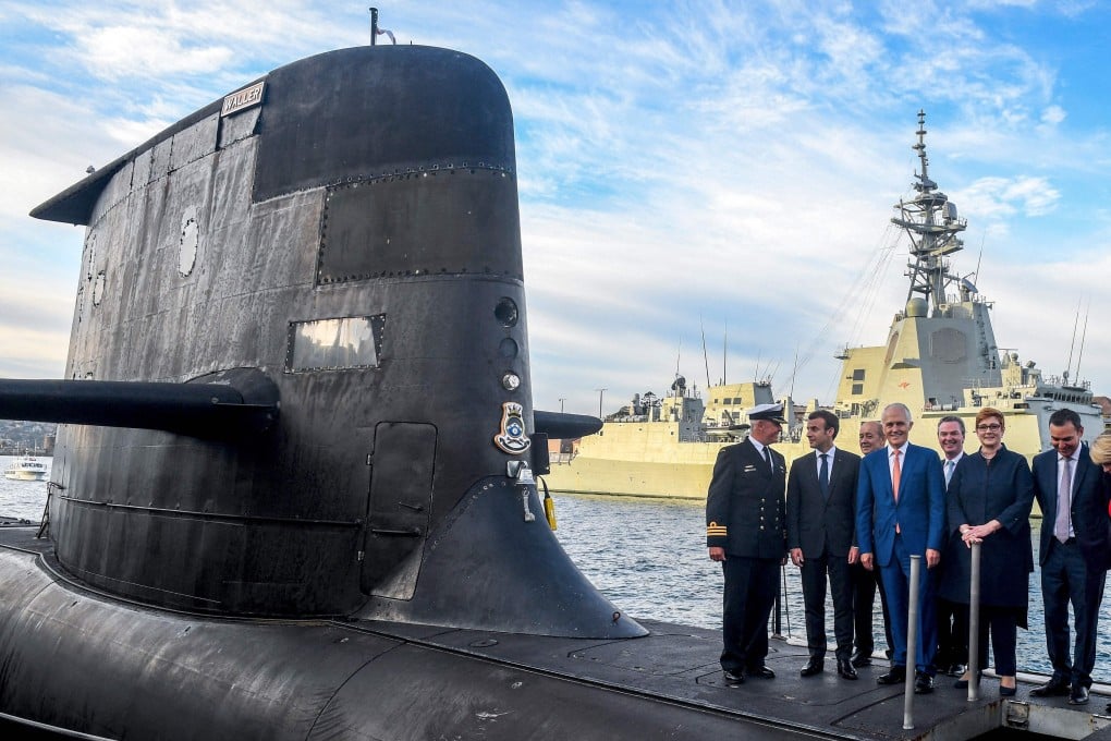 French President Emmanuel Macron, second left, pictured in 2018 standing on the deck of an Australian submarine in Sydney, with former Australian Prime Minister Malcolm Turnbull and other officials. Photo: AFP