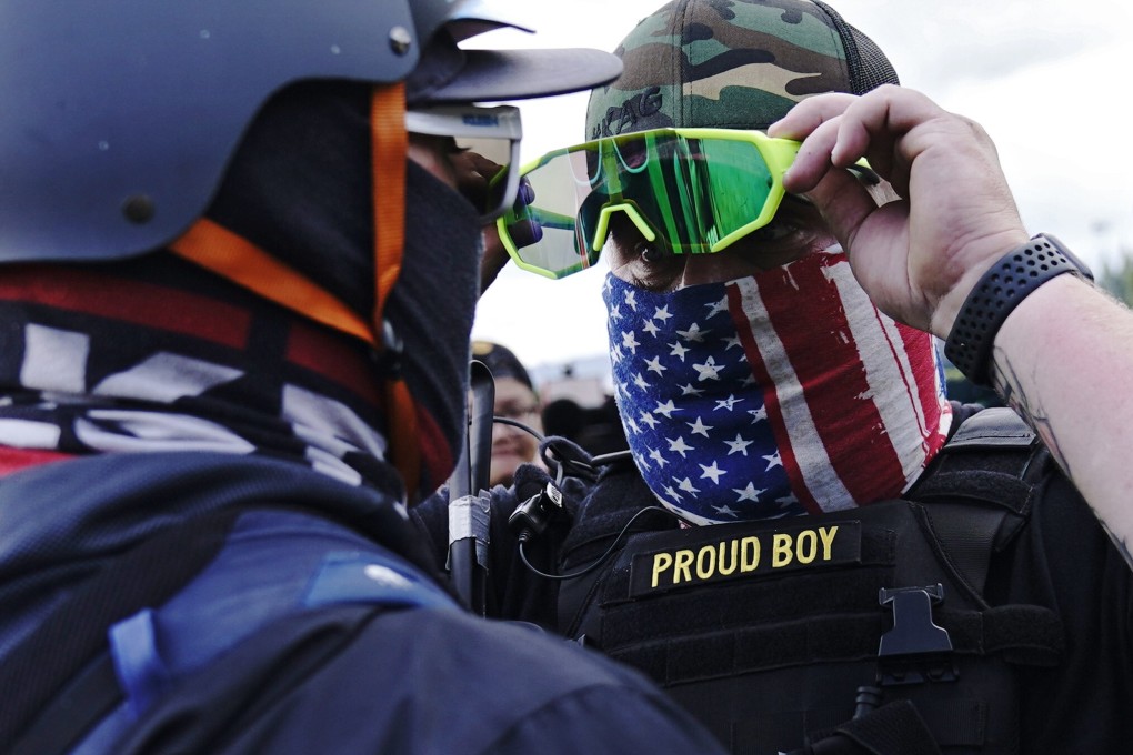 A member of the Proud Boys (right) stands in front of a counter protester in Portland, in the US, in September 2020. Photo: AP