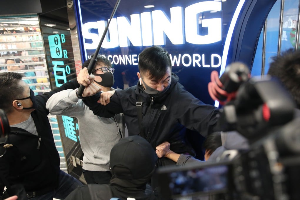 A plain-clothes policeman clashes with anti-government protesters at the Landmark North shopping centre in Sheung Shui on December 28, 2019. Photo: Winson Wong