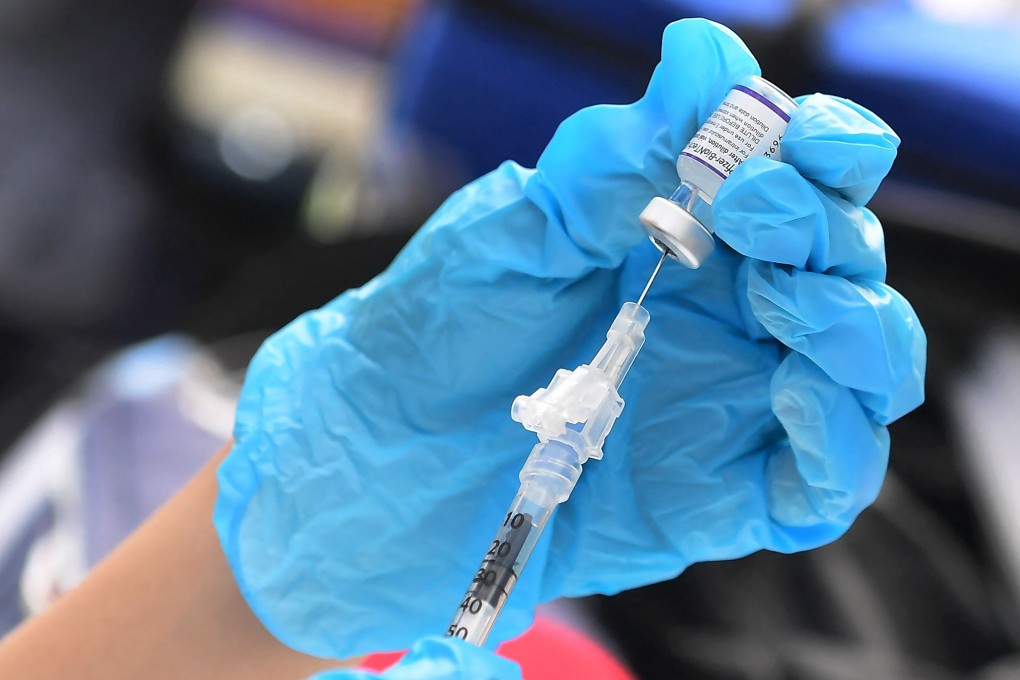 A health worker prepares a dose of the Pfizer Covid-19 vaccine. Those who are elderly or at risk can now receive a booster. Photo: AFP