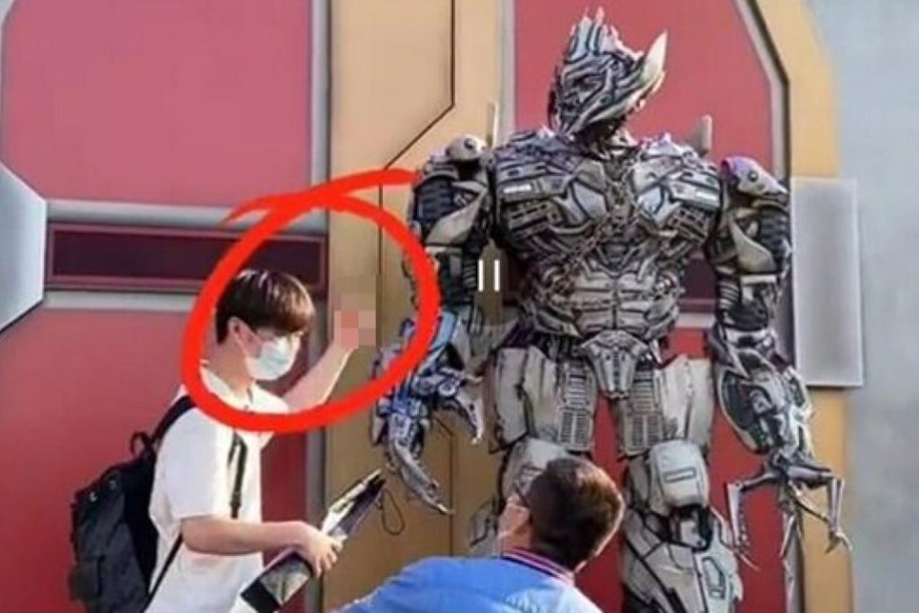 A man gives the finger to Megatron at Universal Beijing Resort. Photo: Handout