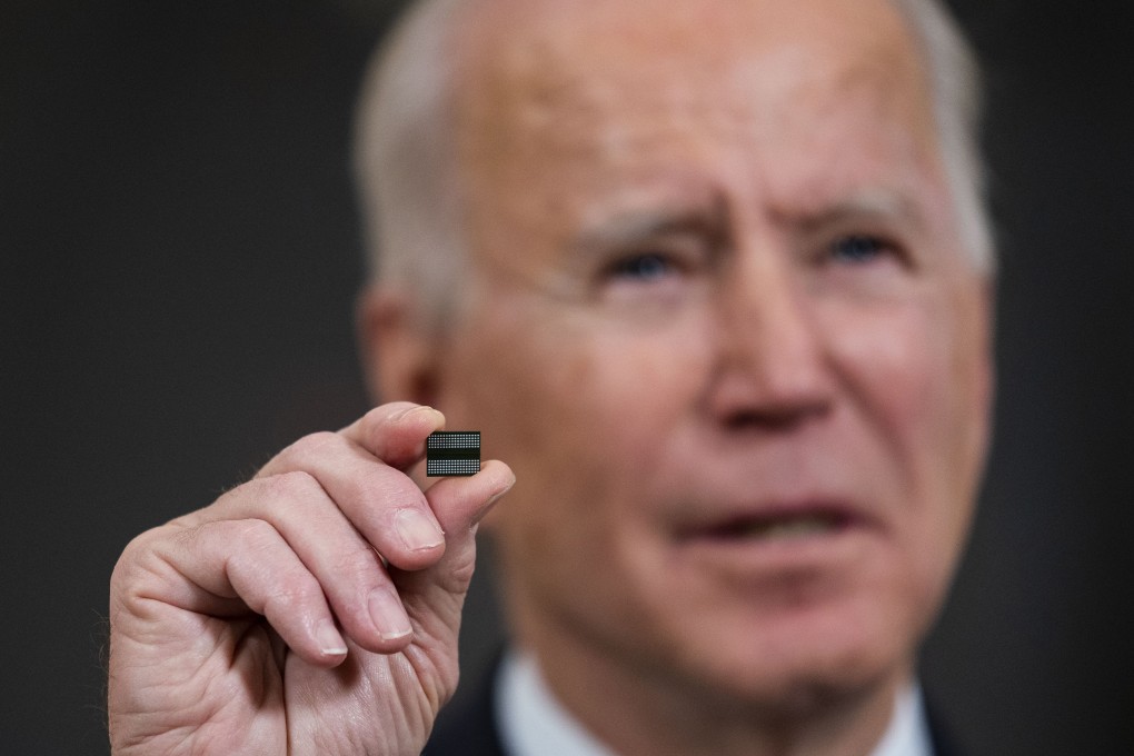 US President Joe Biden holds a semiconductor during his remarks before signing an executive order on the economy in the State Dining Room of the White House on February 24 in Washington. Photo: AFP