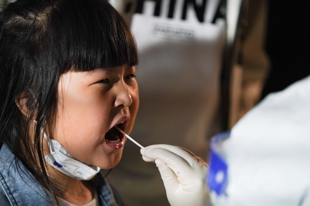 A child is tested for Covid-19 at one of the testing points in Harbin, northeast China. Photo: Xinhua