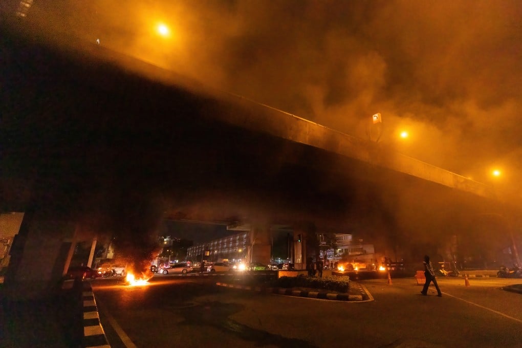 Tyres burn at the Din Daeng intersection as pro-democracy protesters demand the resignation of Prime Minister Prayuth Chan-ocha. Photo: DPA