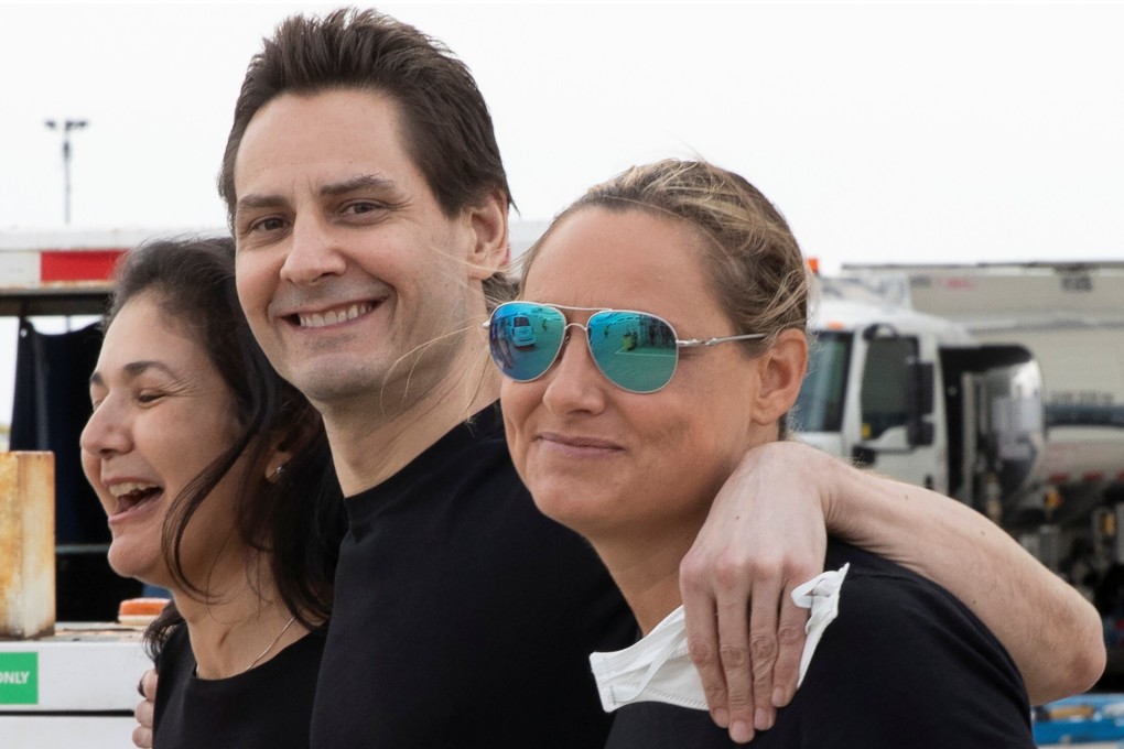 Former diplomat Michael Kovrig meets his wife Vina Nadjibulla and sister Ariana Botha upon his return to Canada on September 25, 2021. Photo: Reuters