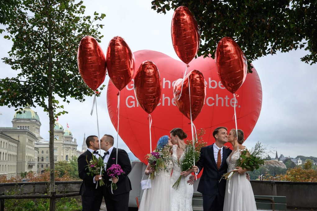 Couples pose during a nationwide referendum day on same-sex marriage, in the Swiss capital Bern on Sunday. Photo: AFP