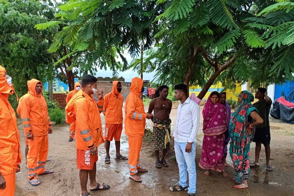 India’s National Disaster Response Force (NDRF) staff ask villagers to take precautions against Cyclone Gulab in Ganjam, eastern Orissa state, India on Sunday. Photo: National Disaster Response Force via AP