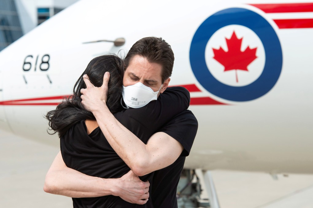Former diplomat Michael Kovrig embraces his wife Vina Nadjibulla in Toronto following his arrival on a Canadian air force jet. Photo: Reuters