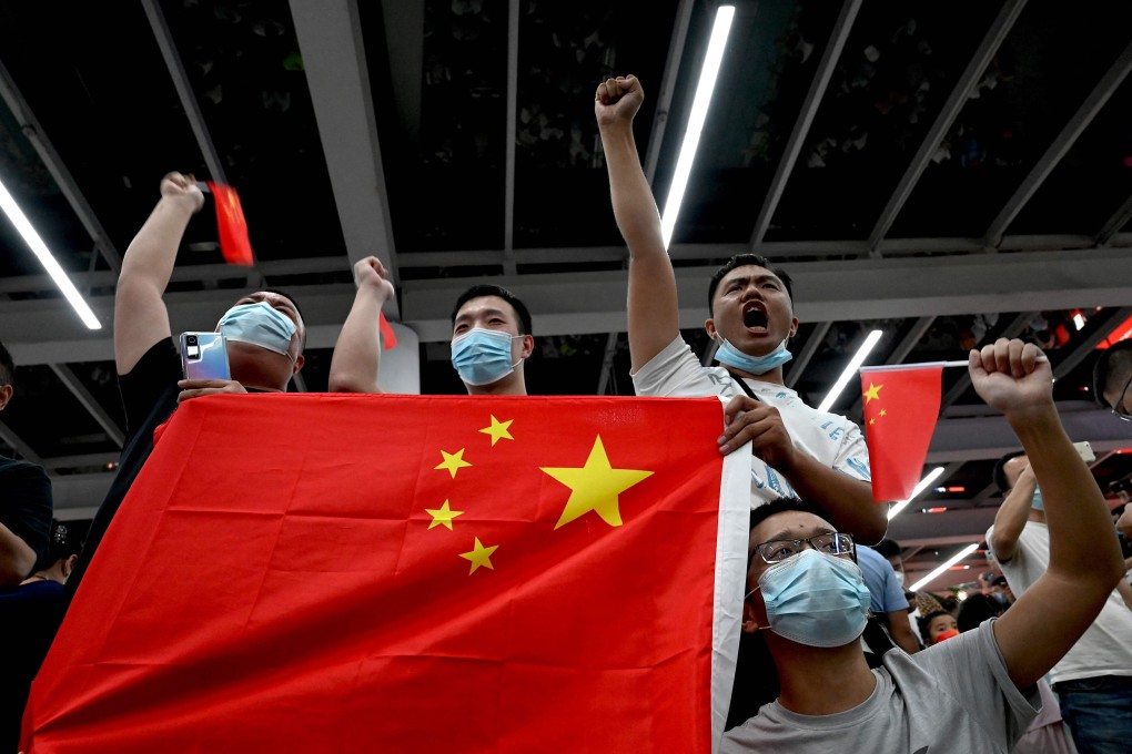 Supporters wave Chinese national flags as they wait for the arrival of Huawei executive Meng Wanzhou. Photo: AFP