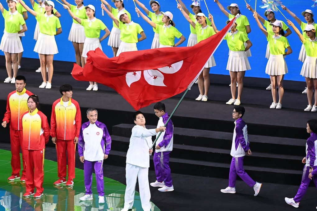 A representative from Hong Kong waves the special administrative region’s flag during National Games closing ceremony in Xian on Monday night. Photo: Xinhua