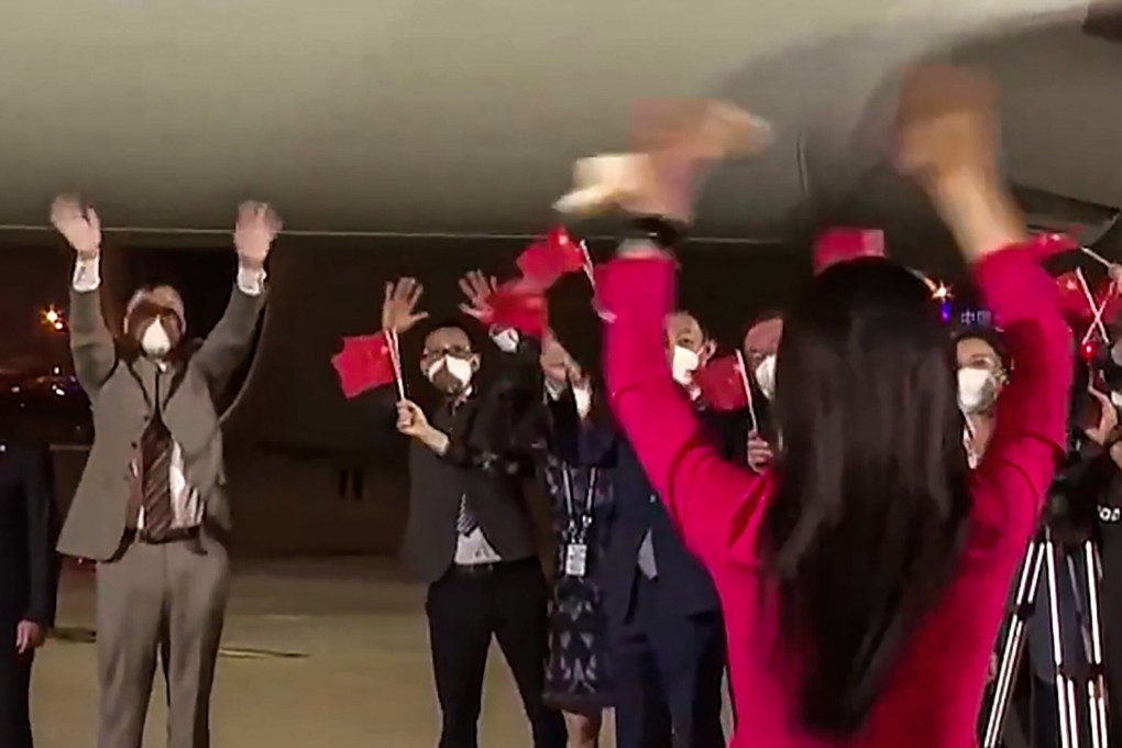 Liu Xiaozong (far left) and his wife Meng Wanzhou wave to each other on the tarmac at Shenzhen Boaon International Airport on September 25. Photo: Handout