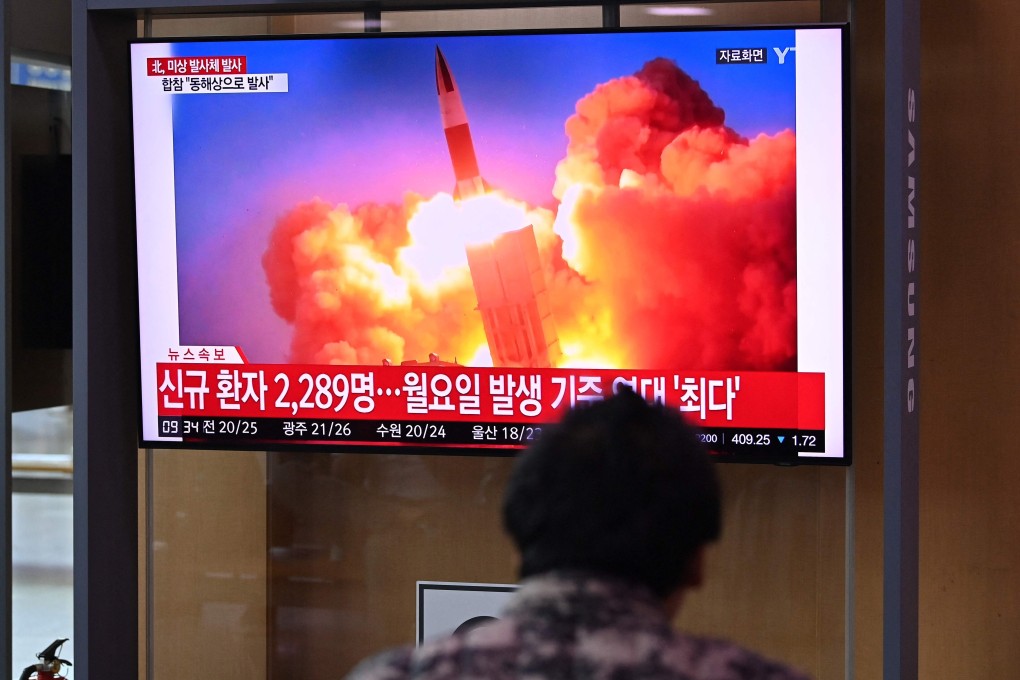 People watch a news broadcast showing file footage of a North Korean missile test. Photo: AFP