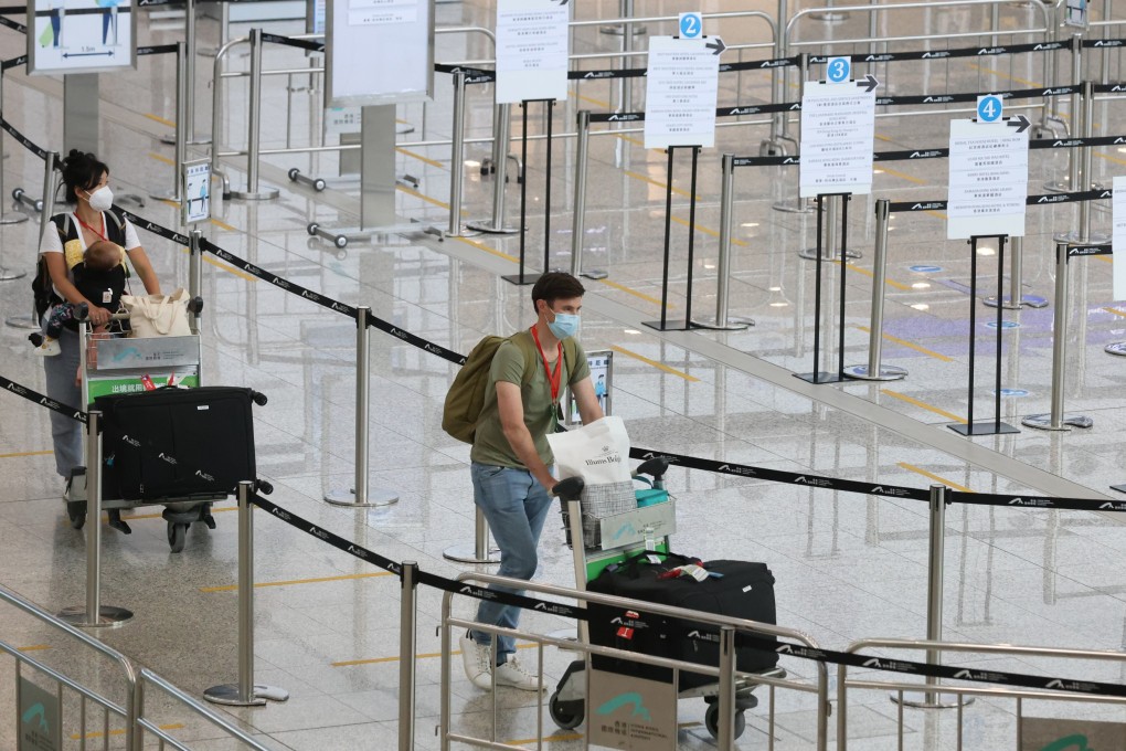 Inbound travellers arriving at Hong Kong International Airport, Chek Lap Kok, get in queue to be transported to quarantine hotels in the city. Photo: SCMP