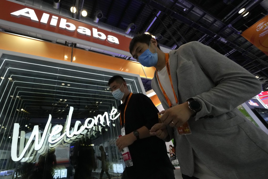 Visitors walk pass by the Alibaba booth at the China International Fair for Trade in Services in Beijing on September 7, 2021. Photo: AP Photo