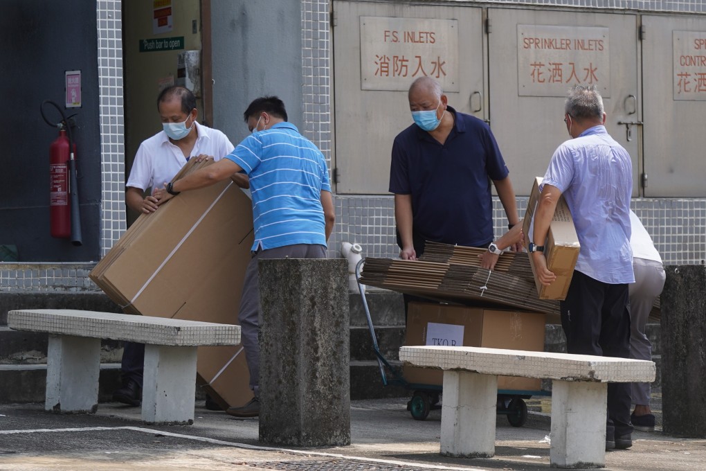 Workers removing boxes of financial records from the Next Digital Building in Tseung Kwan O on September 28, 2021 after the Hong Kong government-appointed special inspector obtained a search warrant to seize documents from the publisher of the now-defunct Apple Daily newspaper. Photo: Sam Tsang.