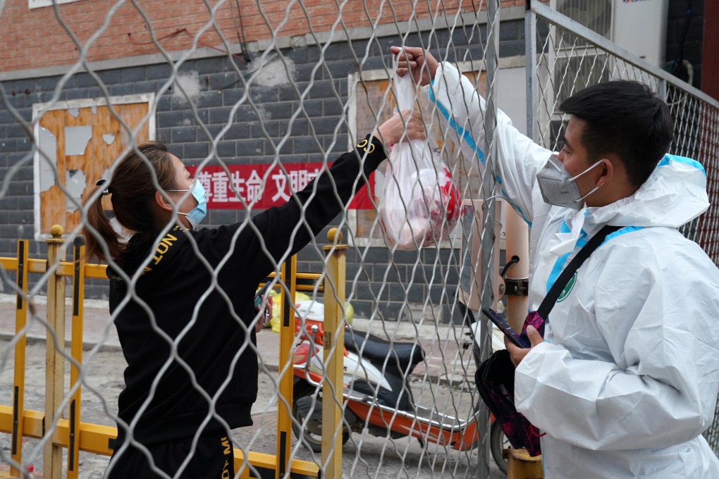 A deliveryman passes a package to a resident in Bayan county in Harbin. Photo: Xinhua