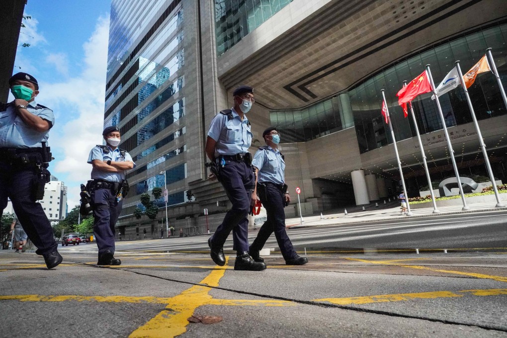 Police officers patrol the streets around the Hong Kong Convention and Exhibition Centre on Election Committee polling day. Photo: Felix Wong