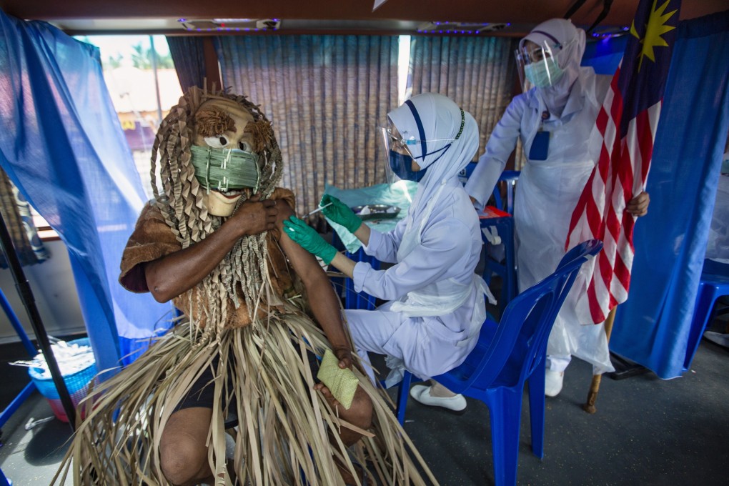 An indigenous man of the Mahmeri tribe receives a dose of the Covid-19 vaccine in Banting, Malaysia. Photo: EPA