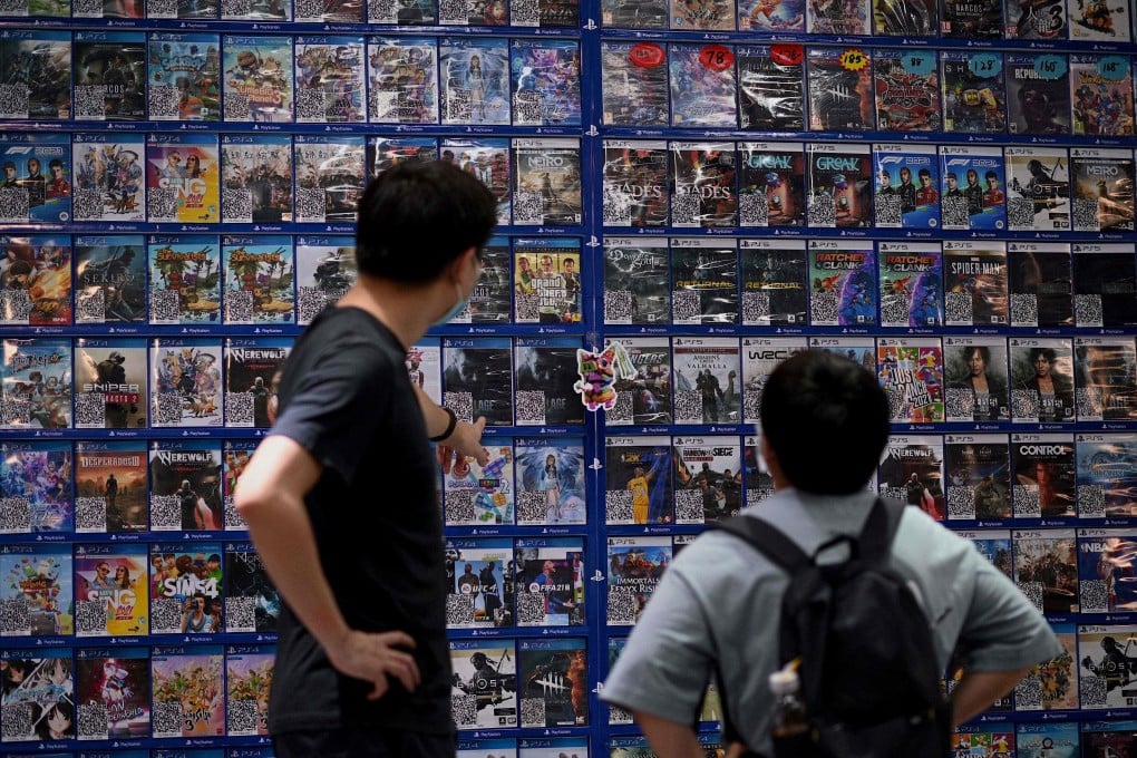 People look at console games at a store in Beijing on August 31, 2021, a day after China announced a drastic cut to children’s online gaming time to just three hours a week. Photo: AFP