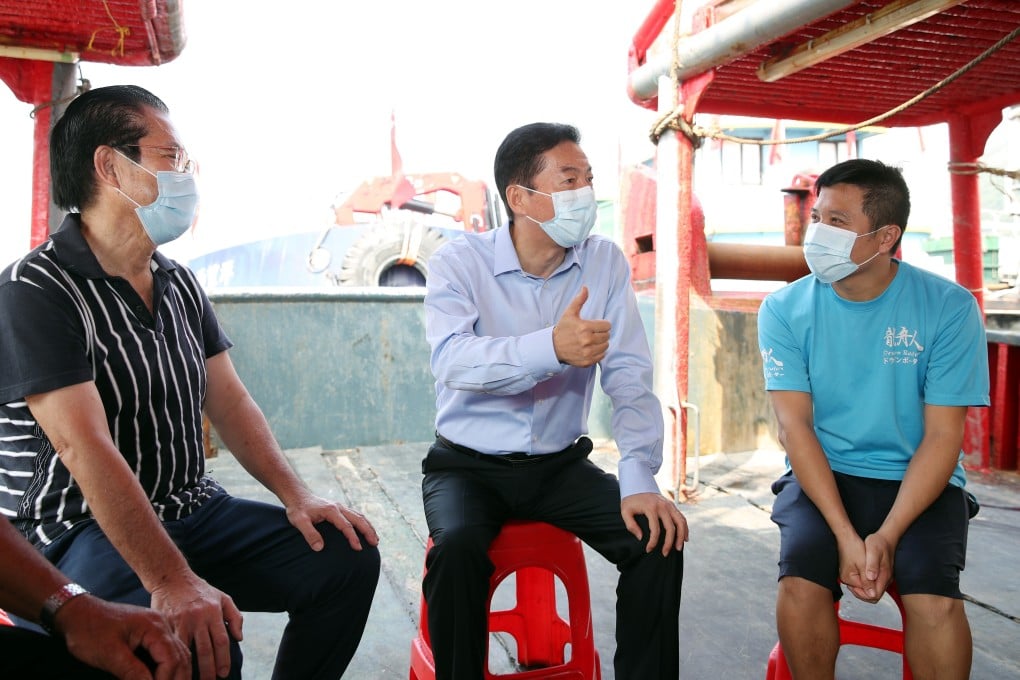 Luo Huining, the director of the central government’s liaison office, talks with fishermen in Aberdeen on Thursday. Photo: Handout