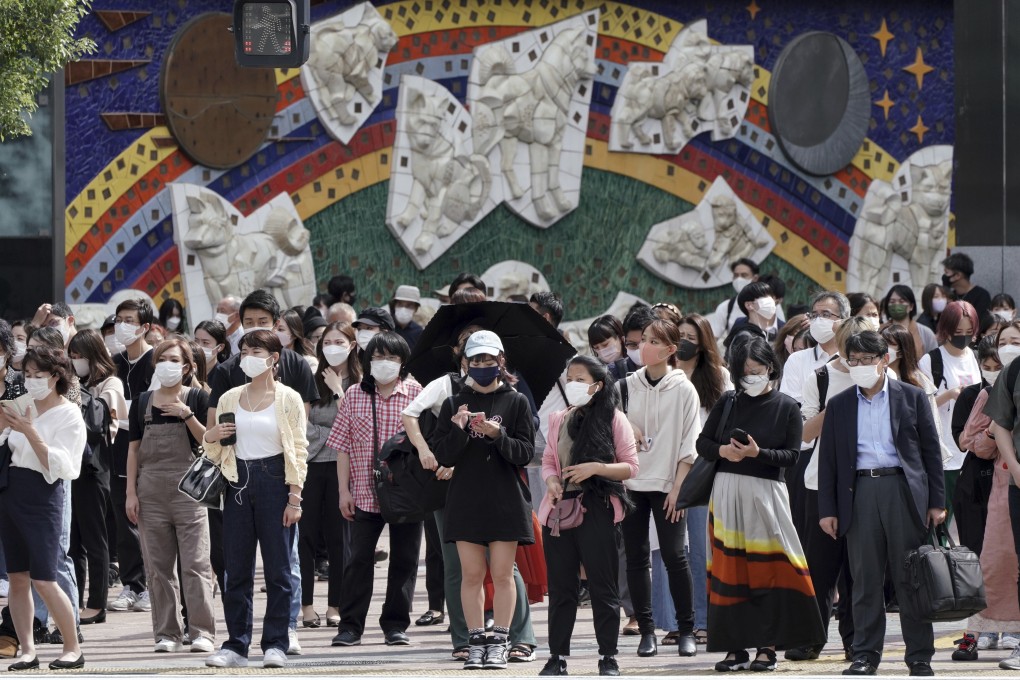 People wait to walk along a pedestrian crossing at Tokyo’s Shibuya district on Thursday. Photo: AP