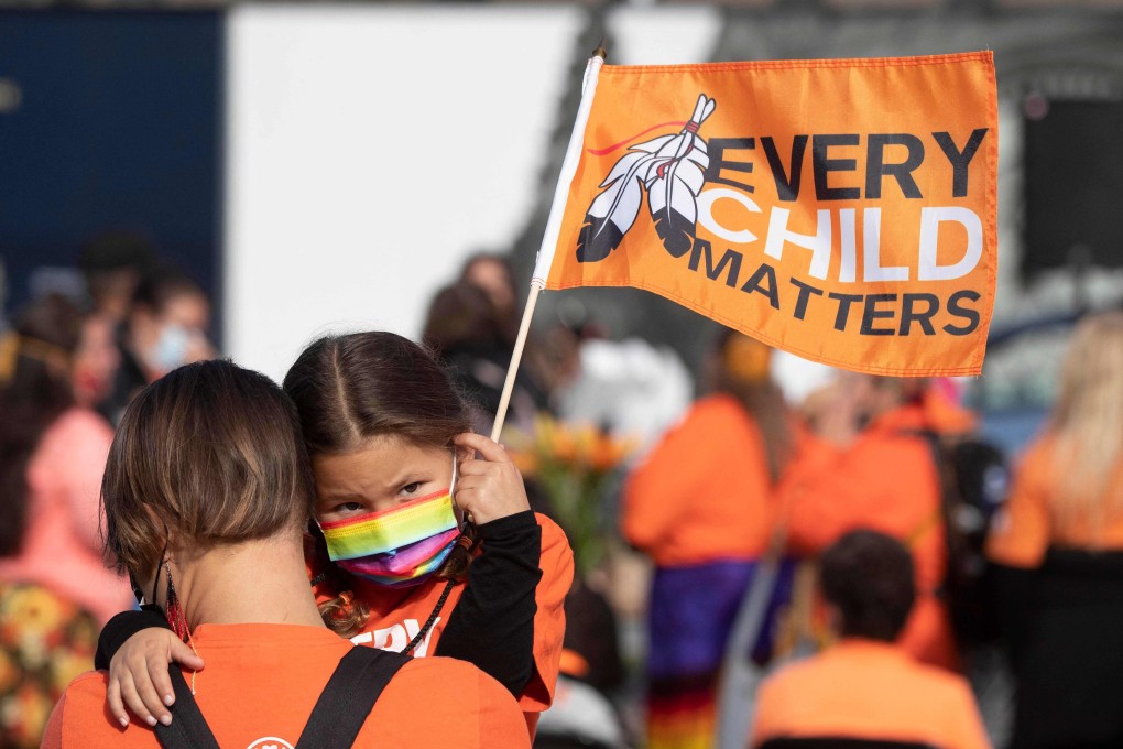 An Indigenous child holds a flag on Parliament Hill in Ottawa during the first National Day for Truth and Reconciliation on Thursday. Photo: AFP