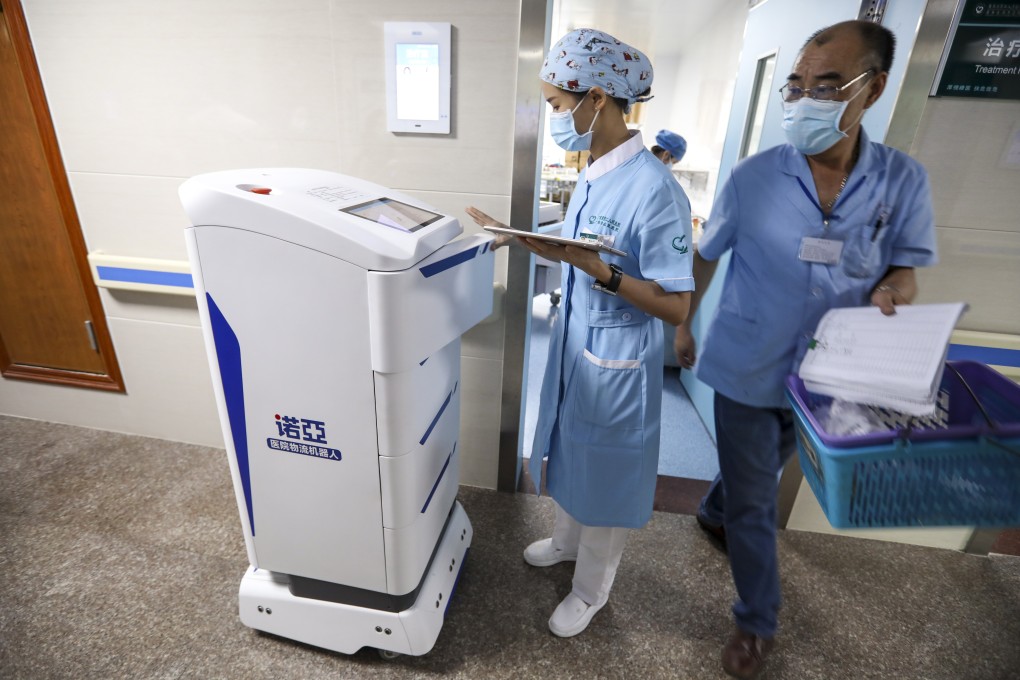 Chen Xiaofang, a nurse at Guangdong Second Provincial General Hospital, operates a robot to deliver supplies to patients in Guangzhou, the capital of Guangdong province, on September 26. Photo: SCMP/Simon Song