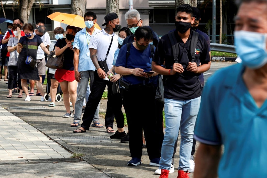 People queue up to take disease antigen rapid tests in Singapore. Photo: Reuters
