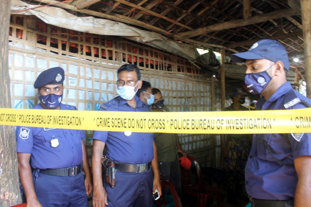 Bangladesh police officials stand guard near the crime scene after the Mohib Ullah a top Rohingya community leader, was shot dead in Cox’s Bazaar. Photo: EPA-EFE