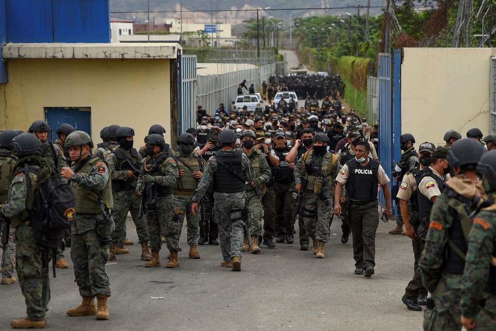 Police are seen walking out of a prison in Ecuador, days after the country's worst-ever riots broke out. Photo: Reuters