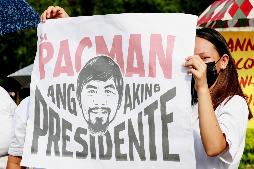 A supporter of Manny Pacquiao carries a banner as he files for candidacy for president on October 1, 2021. Photo: EPA-EFE