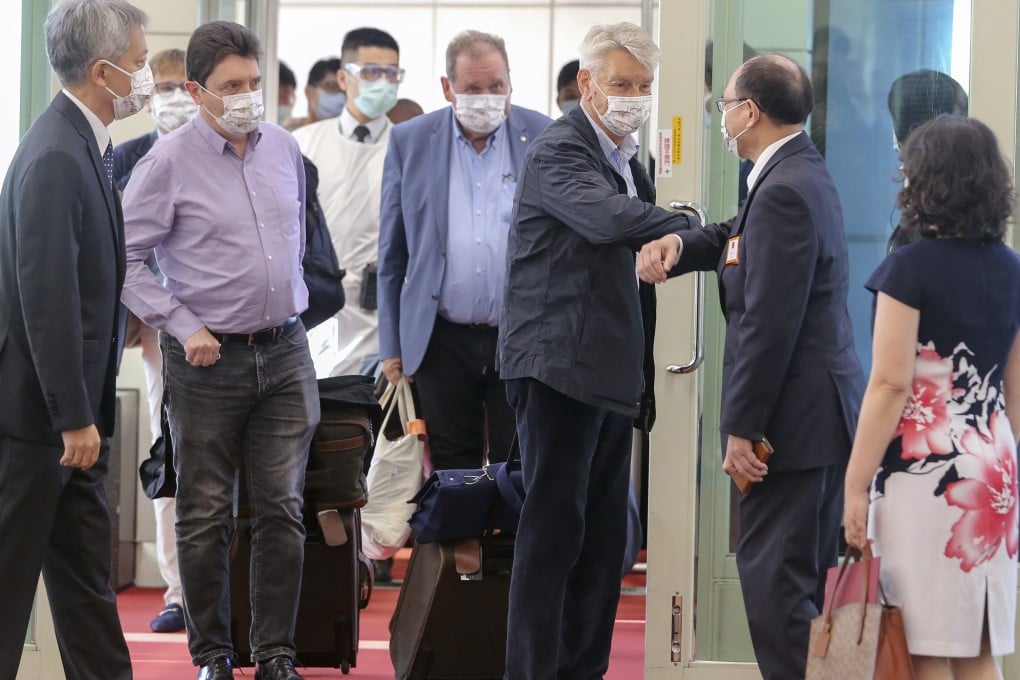 French Senator Alain Richard bumps elbows with a Taiwanese official on arrival at the Taoyuan International Airport in Taiwan on Wednesday. Photo: AP