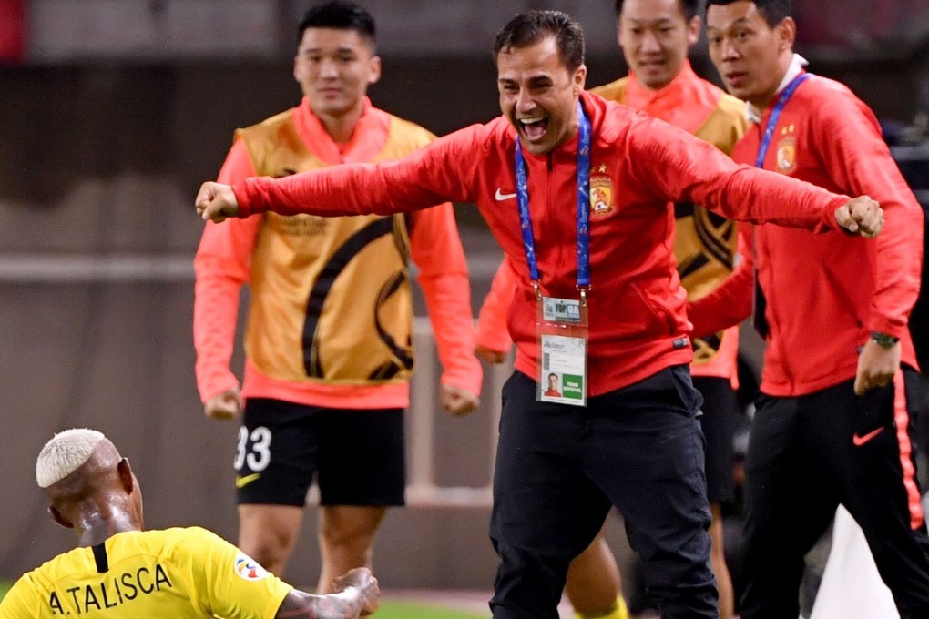 Guangzhou midfielder Anderson Talisca slides on the pitch towards head coach Fabio Cannavaro to celebrate his goal during the 2019 AFC Champions League quarter-finals second leg against Kashima Antlers of Japan. Photo: AFP