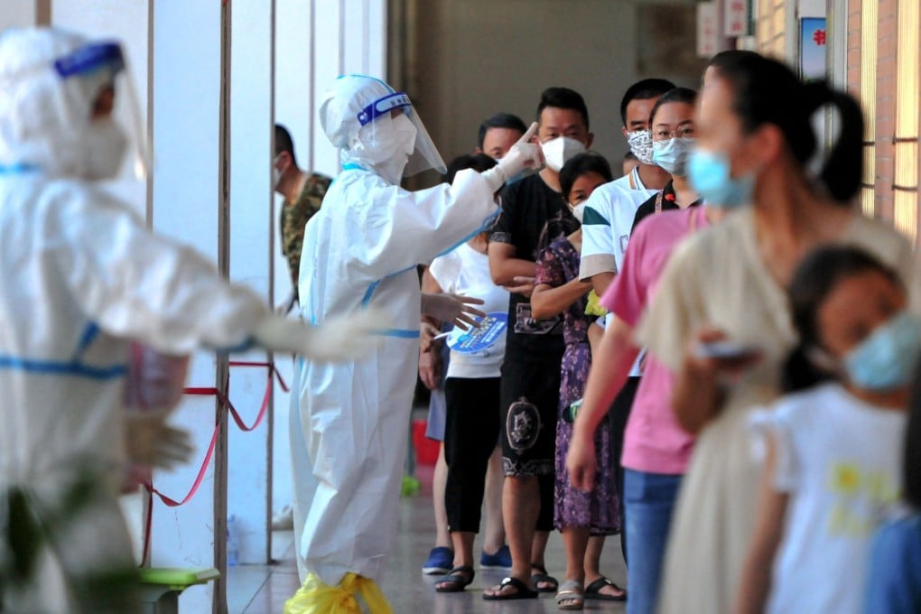 Residents queue to undergo nucleic acid tests for the Covid-19 coronavirus in China which is fighting new outbreaks of the coronavirus. Photo: AFP