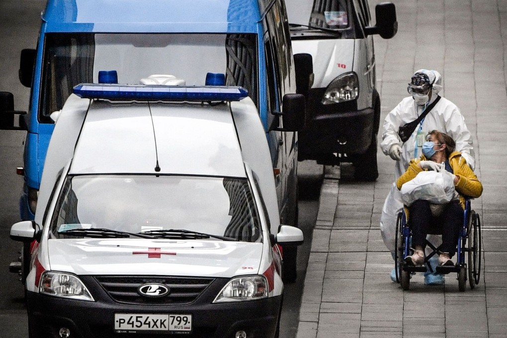 A health worker pushes a woman on a wheelchair at a hospital for Covid-19 patients in Kommunarka outside Moscow on Tuesday. Photo: AFP