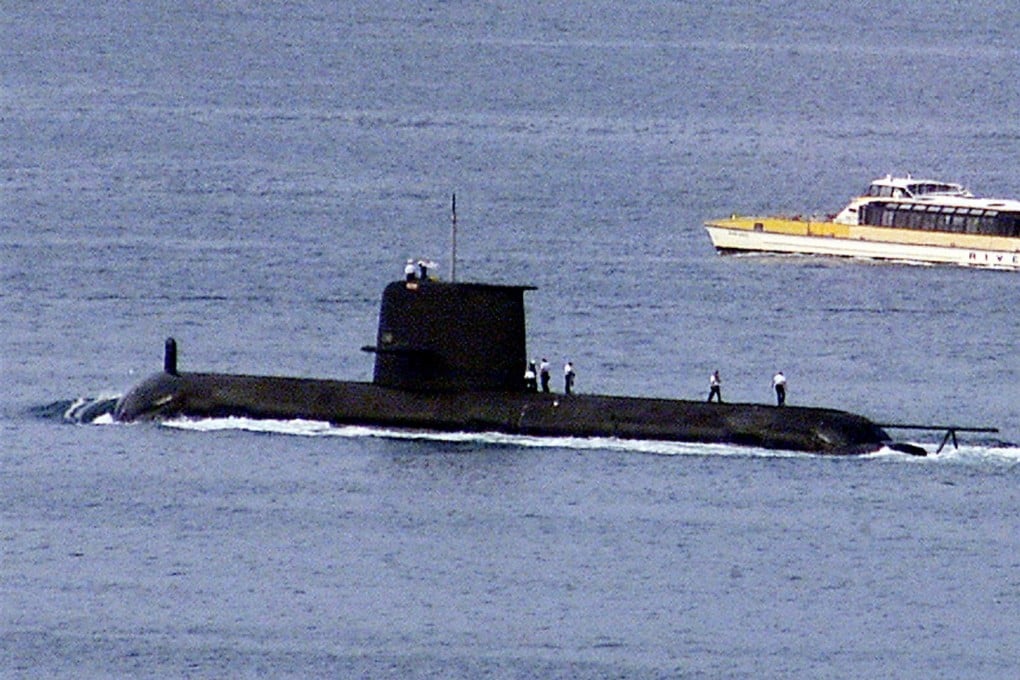 A ferry passes the Royal Australian Navy's Collins-class submarine HMAS Waller as it leaves Sydney Harbour in May 2020. Photo: Reuters