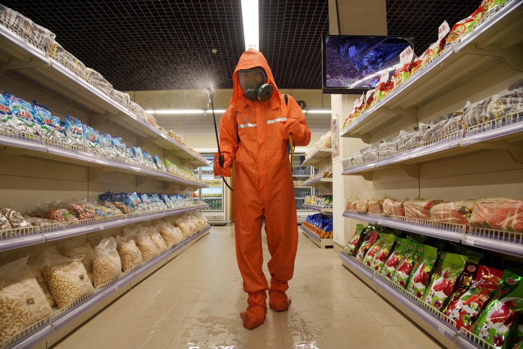 A health official sprays disinfectant in a store in Pyongyang. Photo: AFP