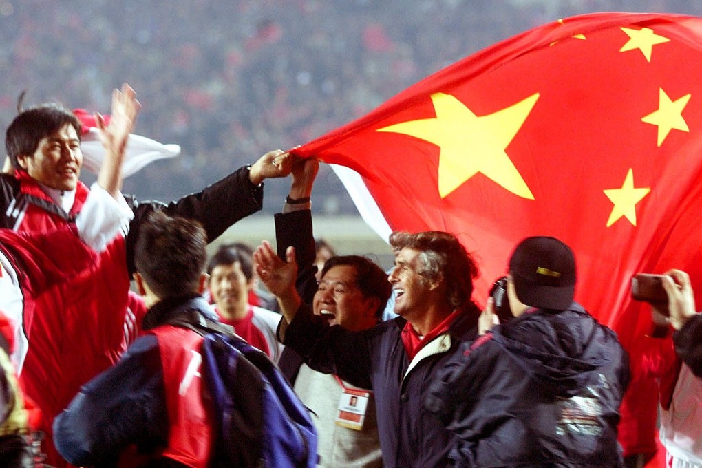 Chinese players and officials celebrate with national team coach Bora Milutinovic (centre, waving right hand) after China's 1-0 victory over Oman in Shenyang on October 7, 2001. The result secured China’s first Fifa World Cup Finals appearance. Photo: Reuters