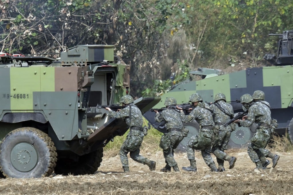 Taiwan special forces personnel walk behind an armoured personnel carrier during an annual military drill in Taichung in January 2017. Photo: AFP