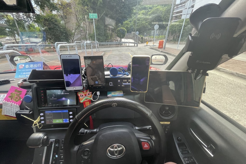 Hong Kong cabbies’ habit of driving while tracking numerous smartphones and devices has raised concerns about road safety. Photo: Handout