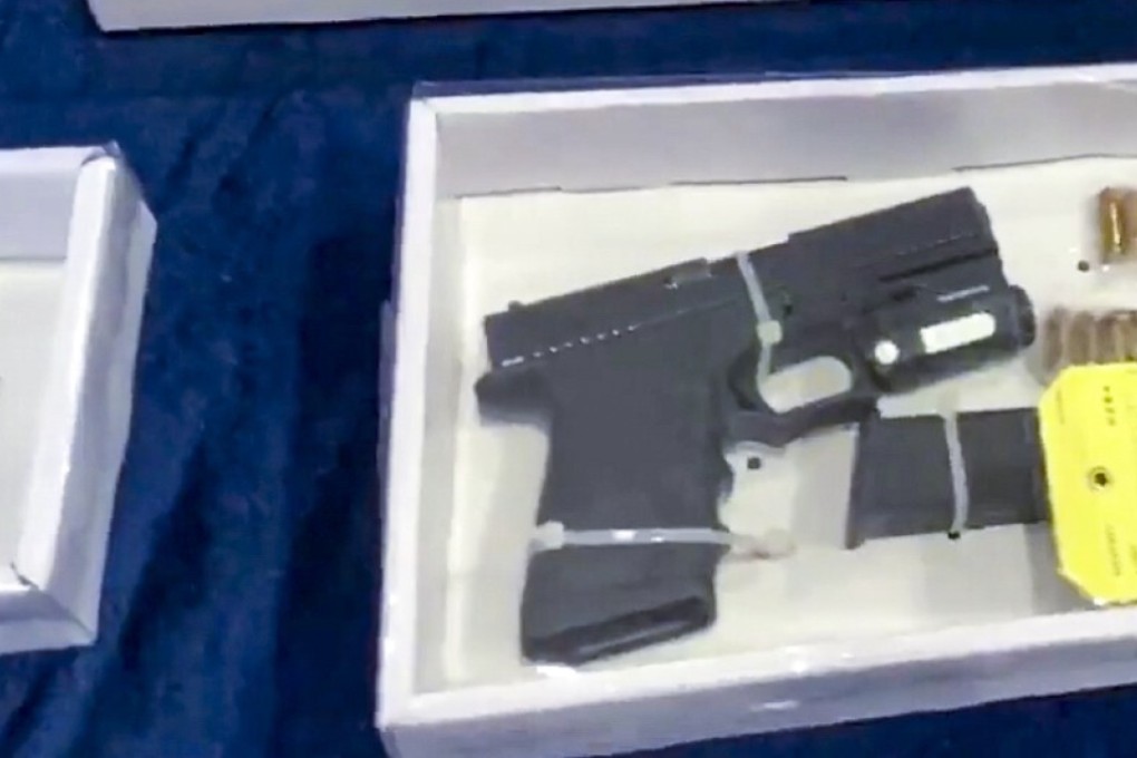 The handgun that police seized during Friday’s raid is displayed along with other evidence. Photo: Facebook